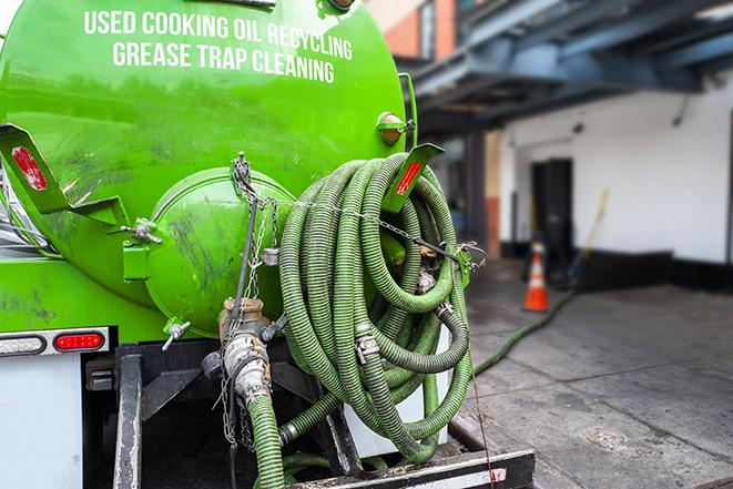 a professional technician pumping a restaurant's grease trap in Bourbon, IN